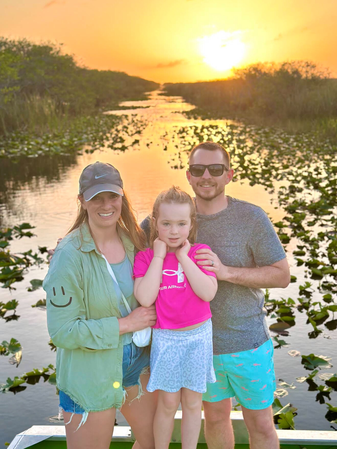 Airboat crossing open water at sunset