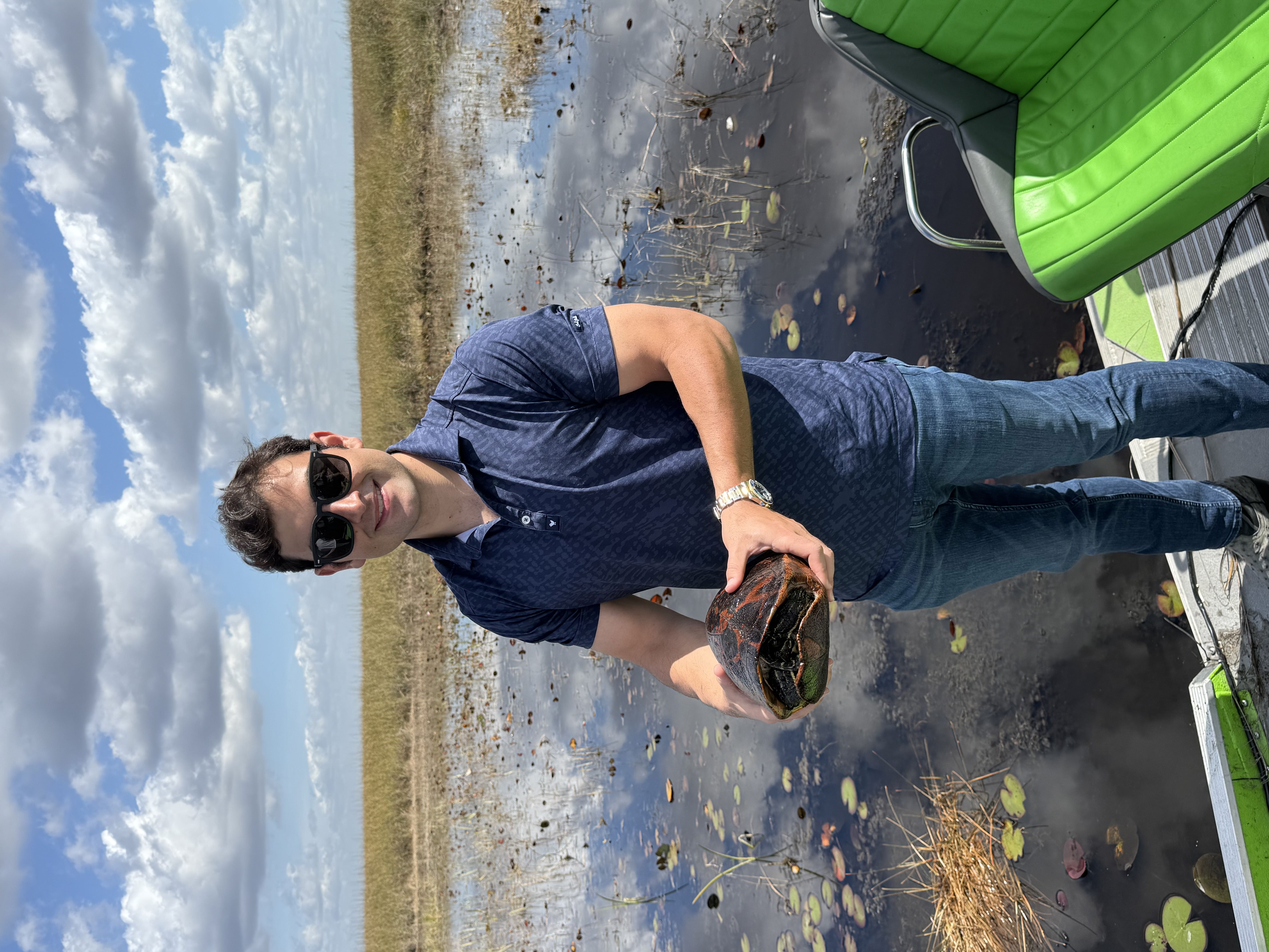 Angler holding a largemouth bass caught in the Everglades